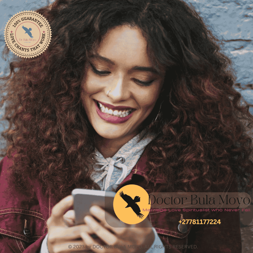 A person smiling at a text; lighthearted messaging; positive phone interaction; relaxed communication.