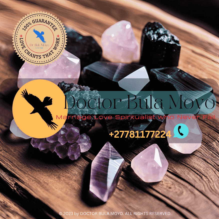 Black Tourmaline, Amethyst, and Rose Quartz crystals placed on a wooden table.