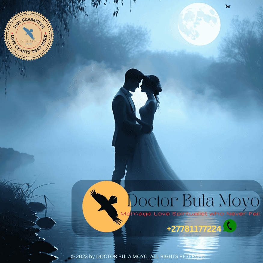 Silhouetted couple in a dreamy mist with moonlight reflecting in water.