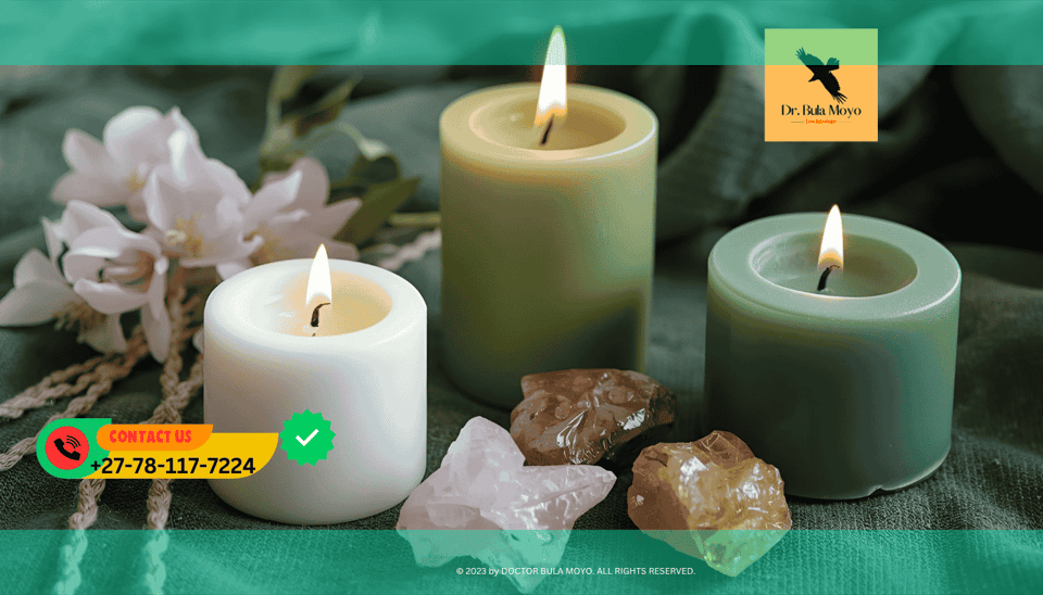 Person performing candle ritual with white, pink, and green candles to release past-life karma in love and finances.