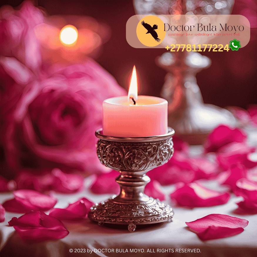 A pink candle burning in a ritual for love manifestation.