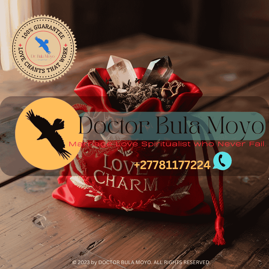 A red silk love charm bag filled with herbs and crystals.