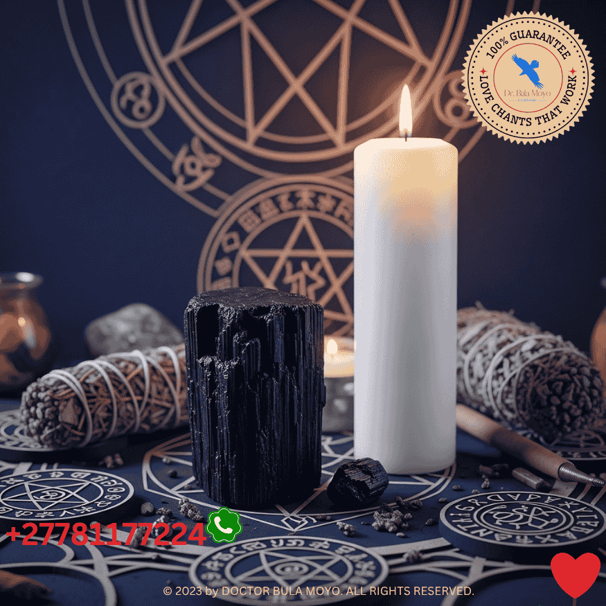 Black tourmaline and white candle on altar for protection against spellwork